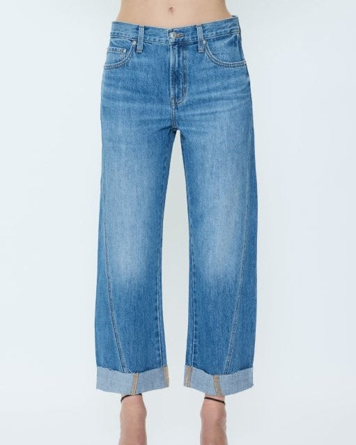 Blue jeans worn by a person on a white background