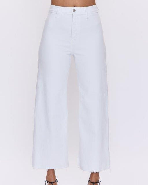 White pants worn by a person on a white background