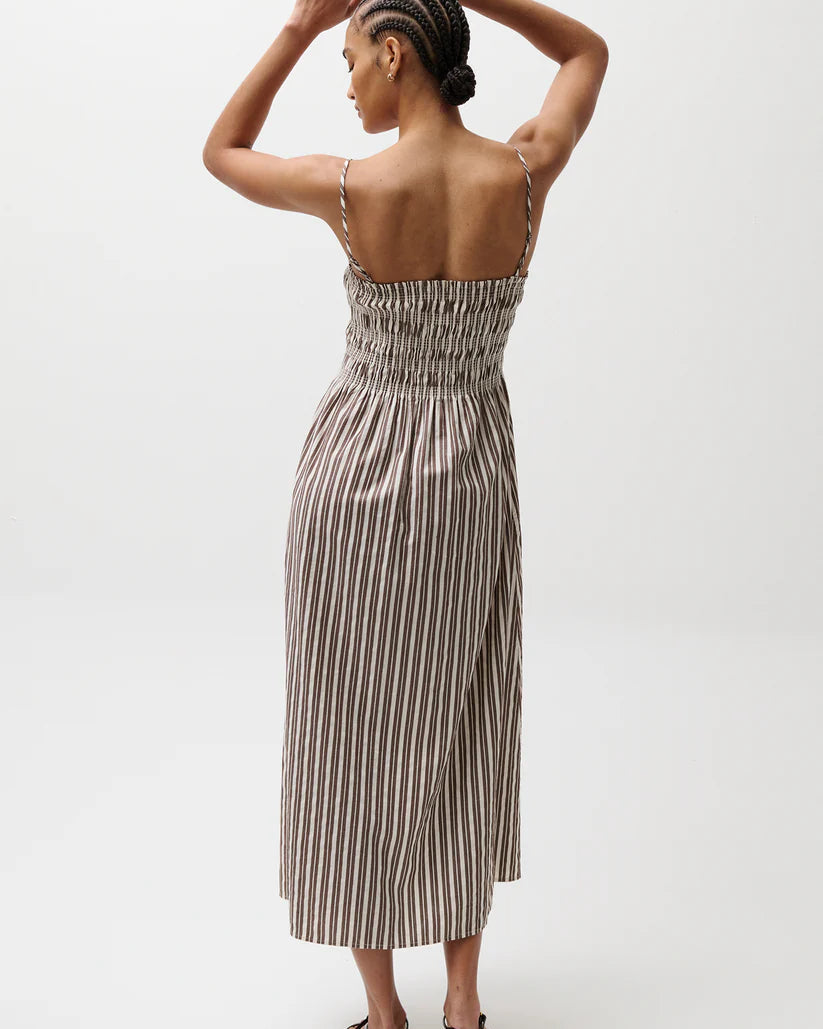Woman wearing a striped dress on a white background