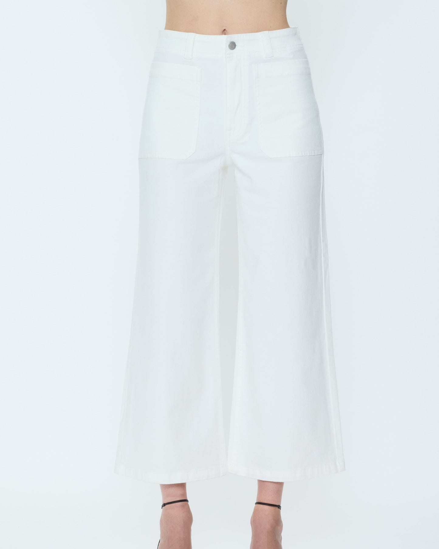 White pants worn by a person on a white background