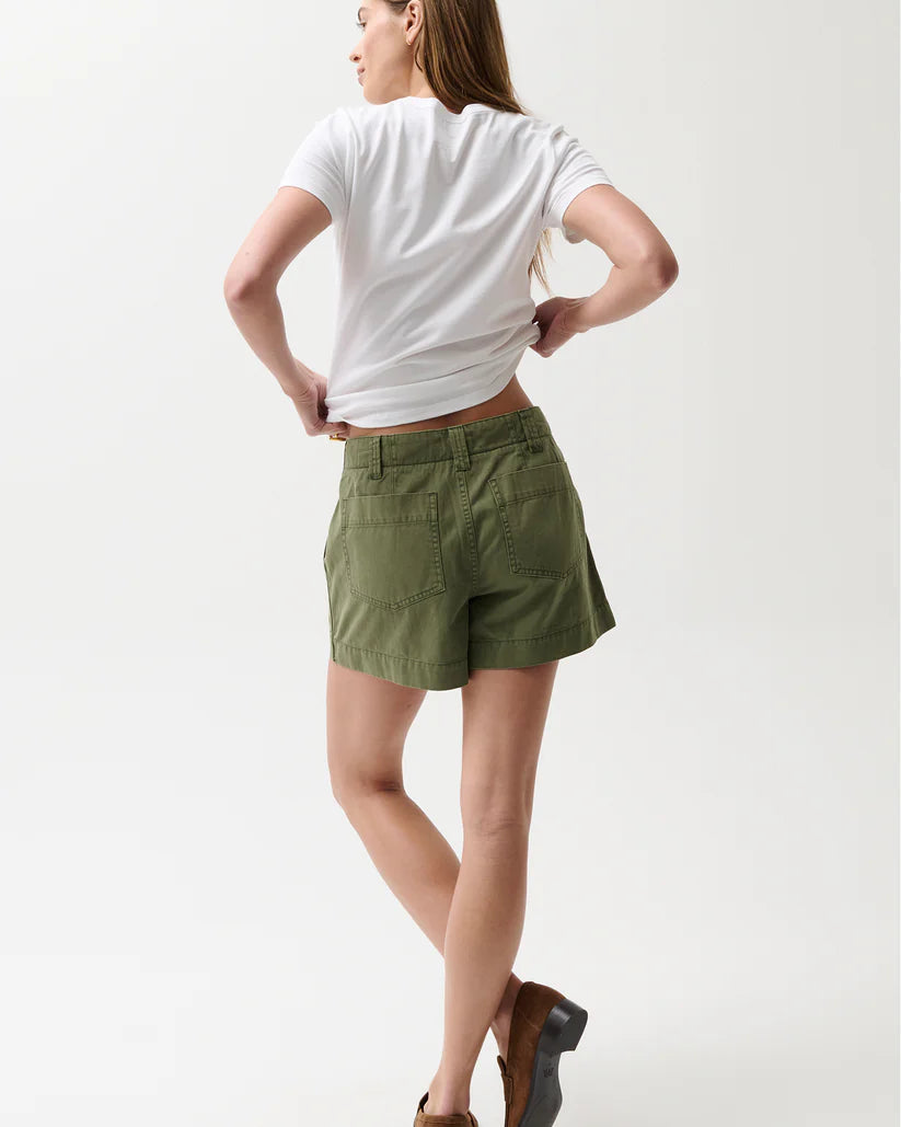 Person wearing a white t-shirt and green shorts on a white background