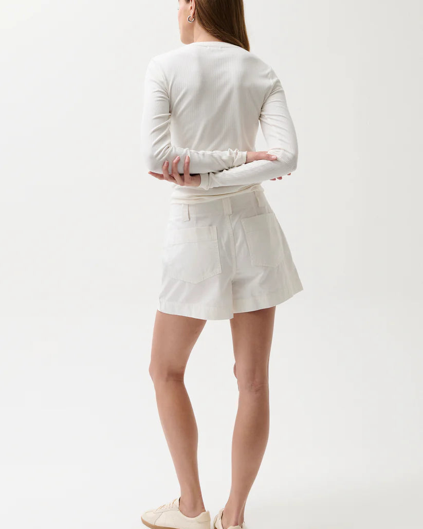 Person wearing a white outfit on a plain background