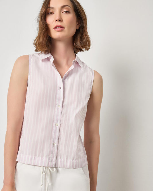 Woman wearing a sleeveless pink striped shirt against a plain background