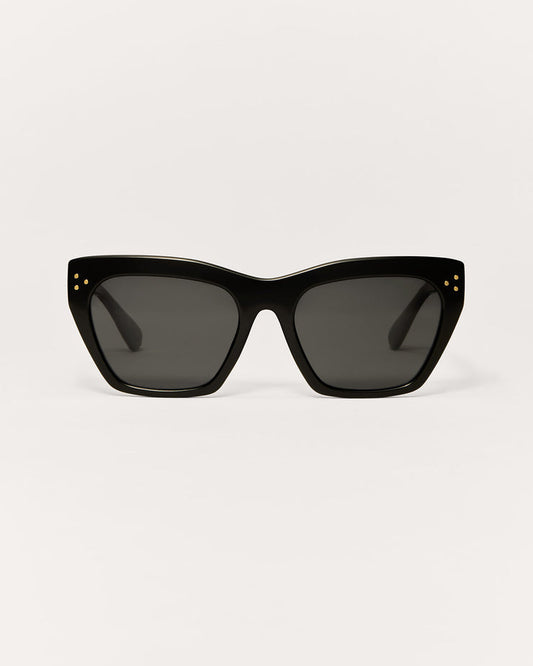 Black cat-eye sunglasses on a light gray background
