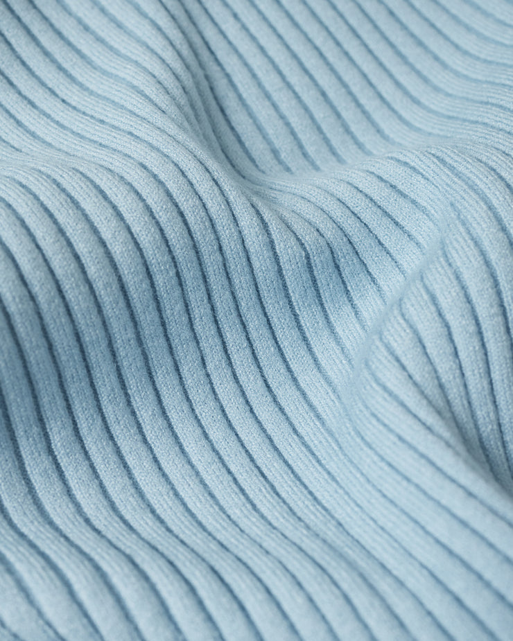 Close-up of textured light blue fabric with subtle patterns