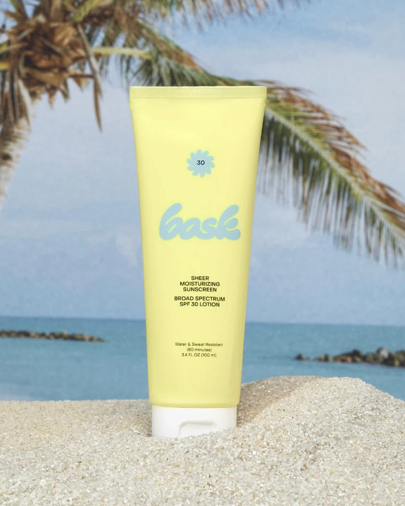 Tube of sunscreen with brand logo on a beach background