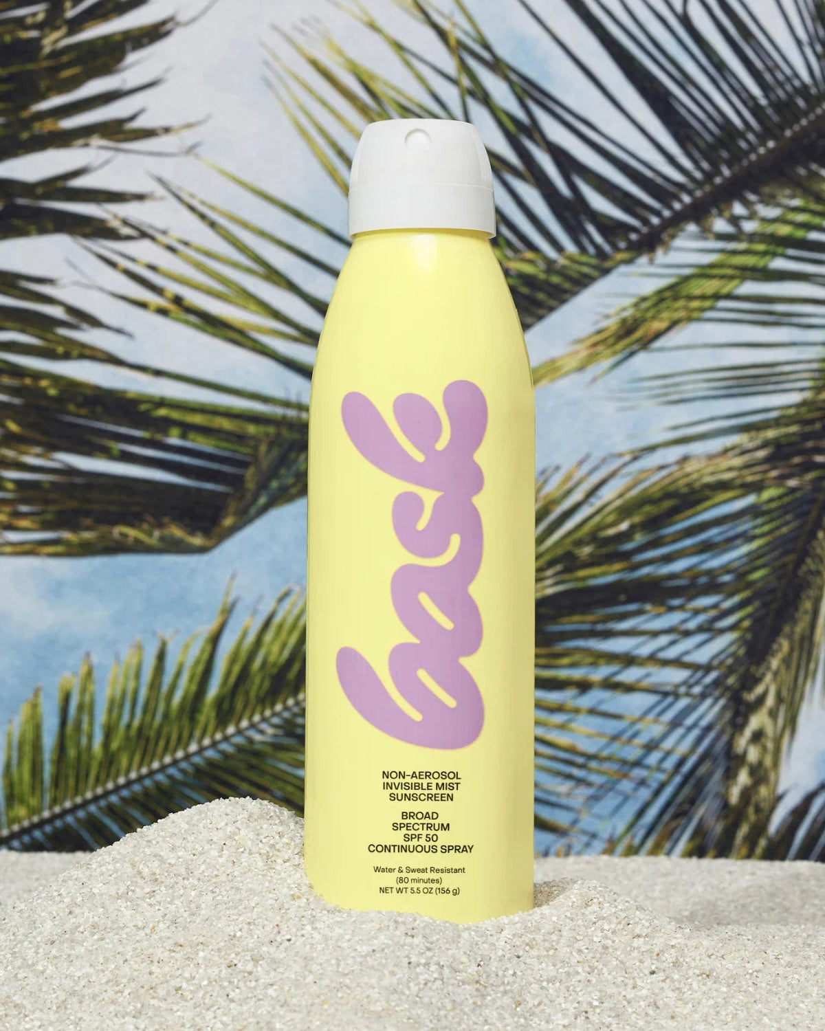 Yellow bottle with pink text on a beach background