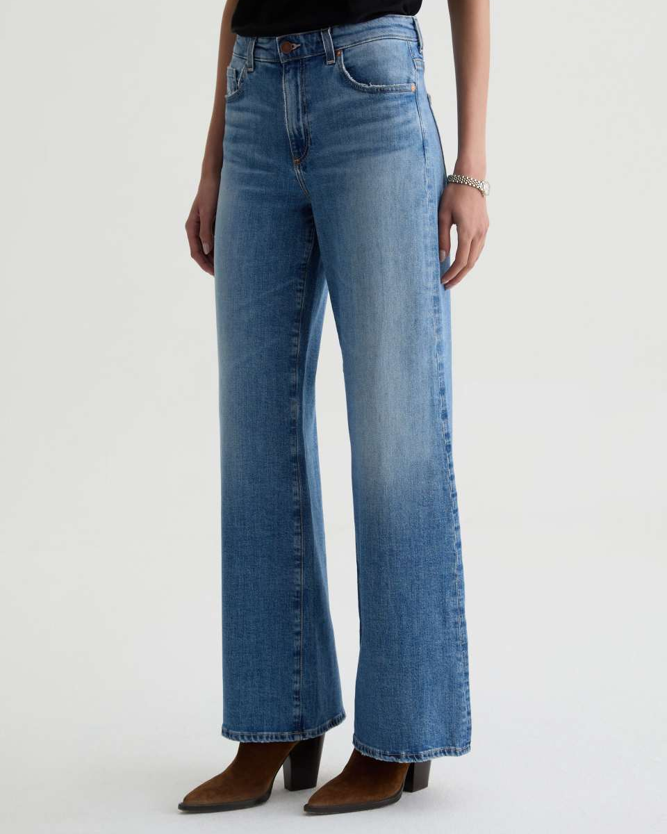 Blue jeans worn by a person on a white background