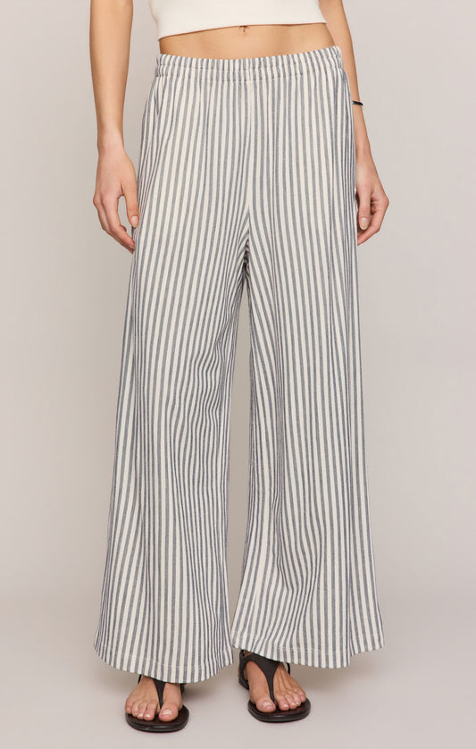 Striped wide-leg pants worn by a person on a plain background