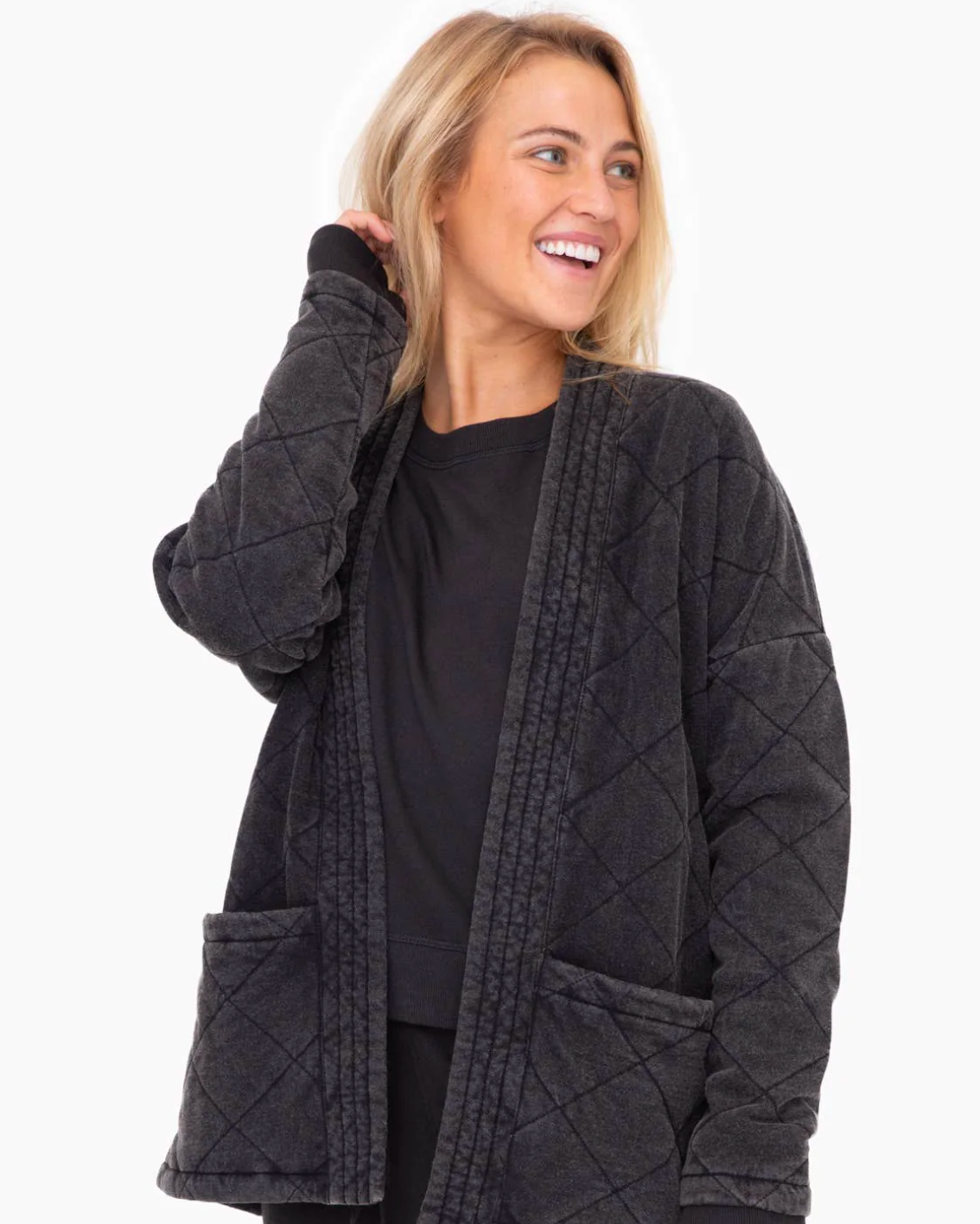 Model wearing Mono B Quilted Mineral Washed wrap jacket in black on a white background