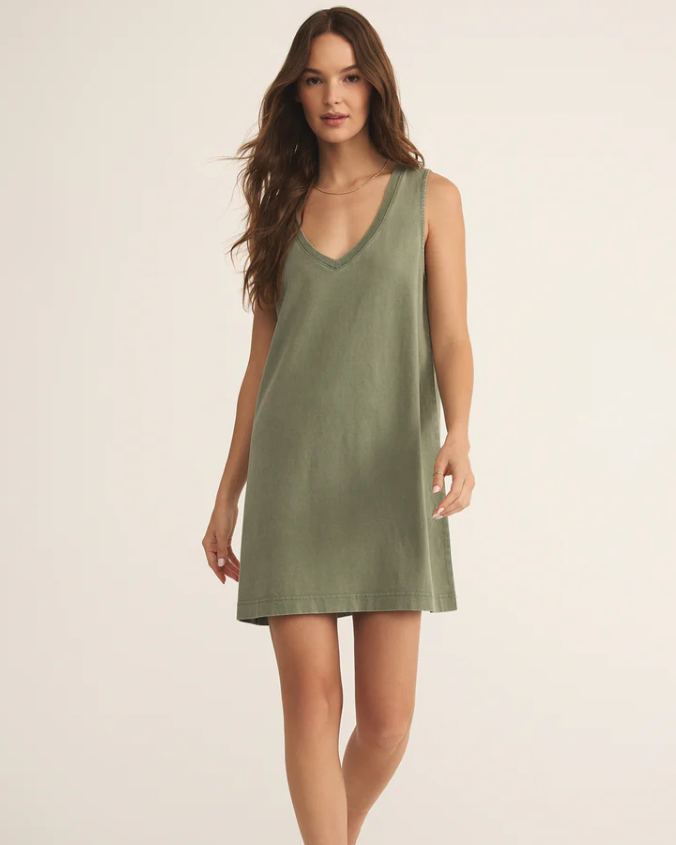 Woman wearing a green sleeveless dress on a white background