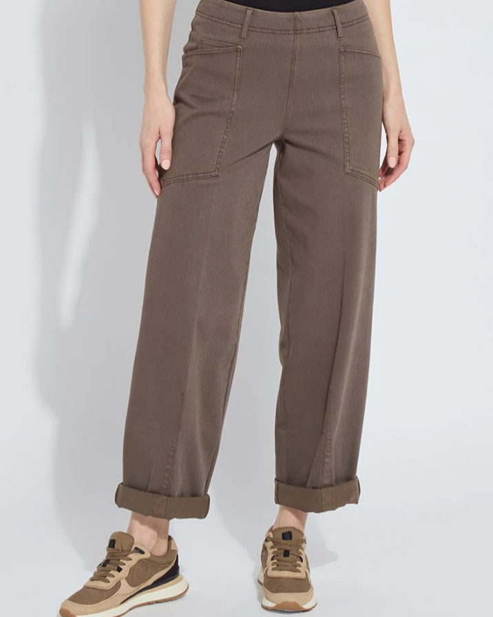 Person wearing brown pants and matching shoes on a white background