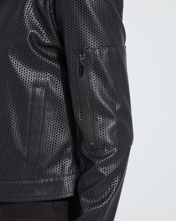 Person wearing a black leather jacket with a white background