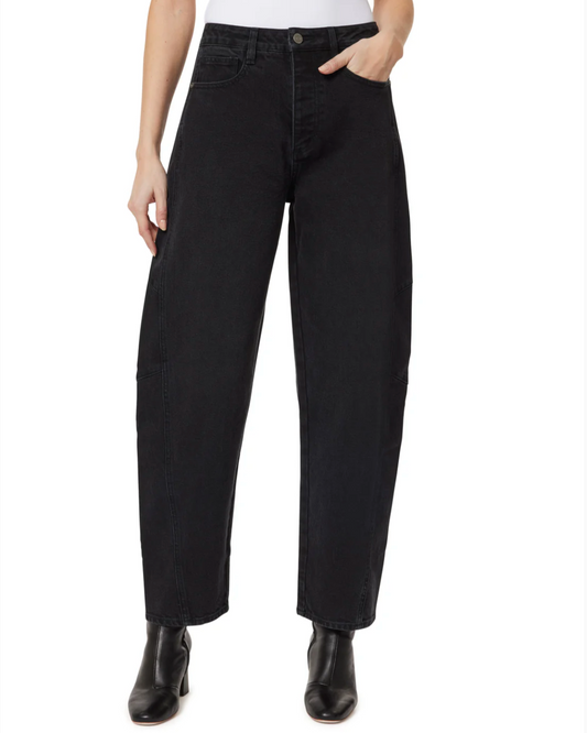 Person wearing black jeans on a white background