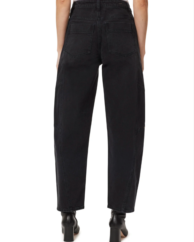 Black pants worn by a person on a white background