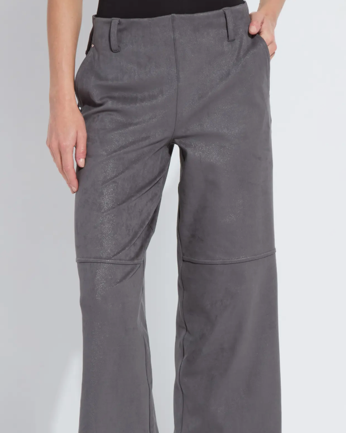 Person wearing gray wide-leg pants and black boots on a white background