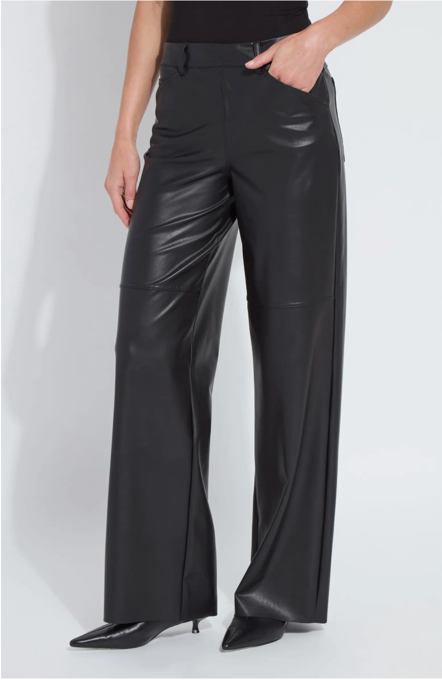 Person wearing black leather pants on a white background