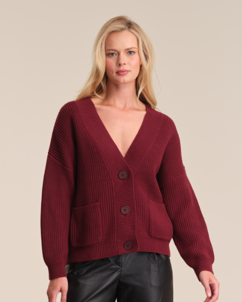 Model is wearing 525 America CELESTE BUTTON DOWN CARDIGAN in color OXBLOOD