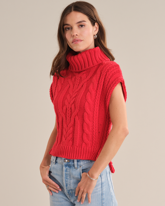 Model wearing the 525 America Angelina vest in true red with denim posing in front of a white background.