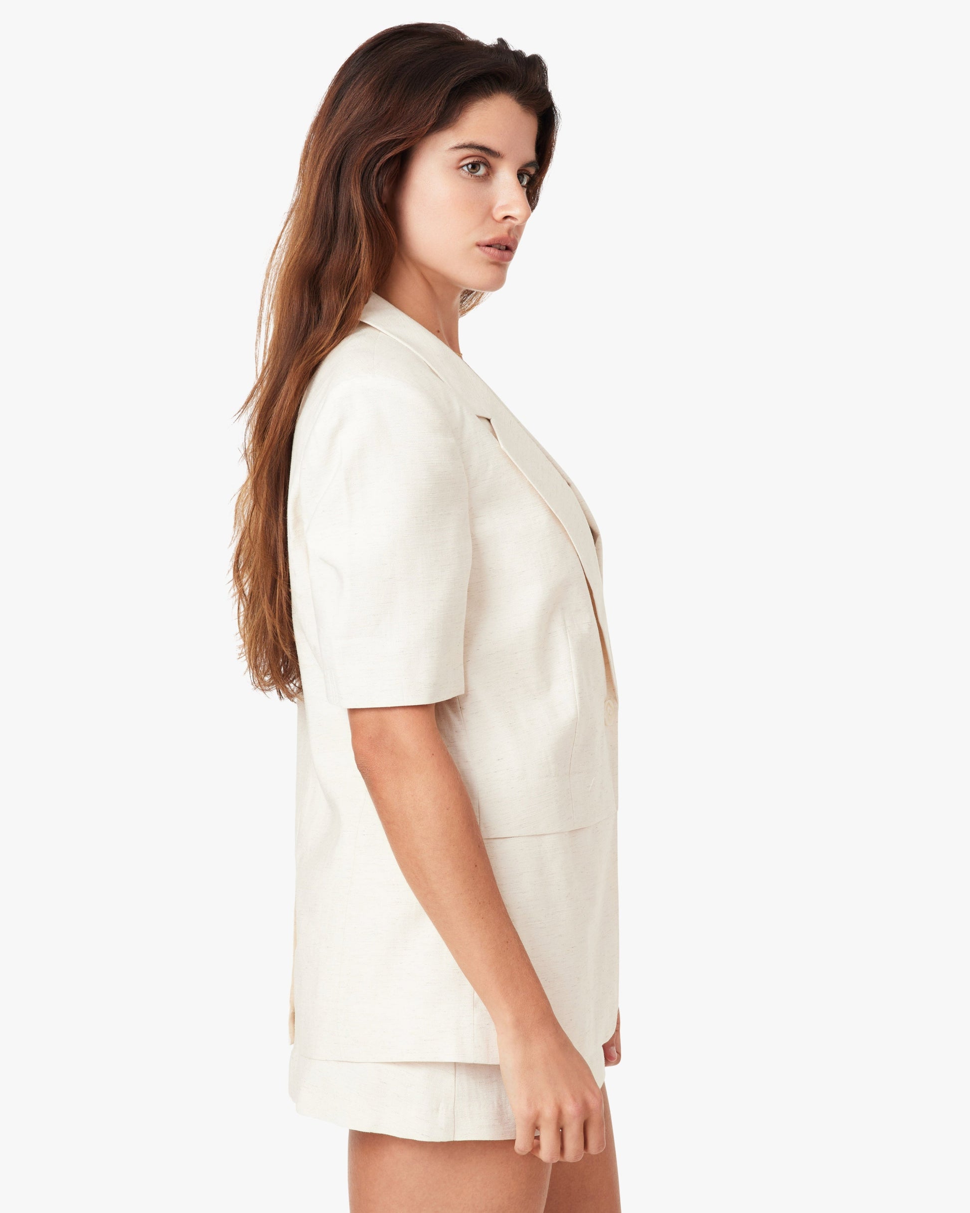 Woman wearing a white outfit on a white background