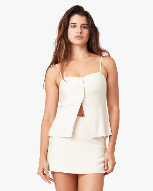 Woman wearing a white dress with a cutout design on a white background
