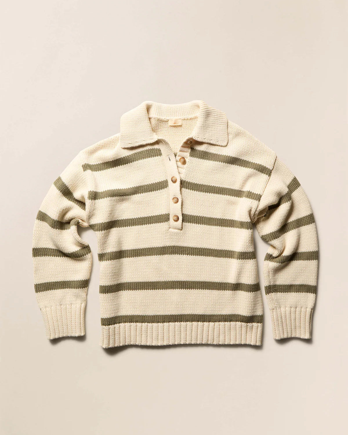 Striped sweater with button collar on a beige background