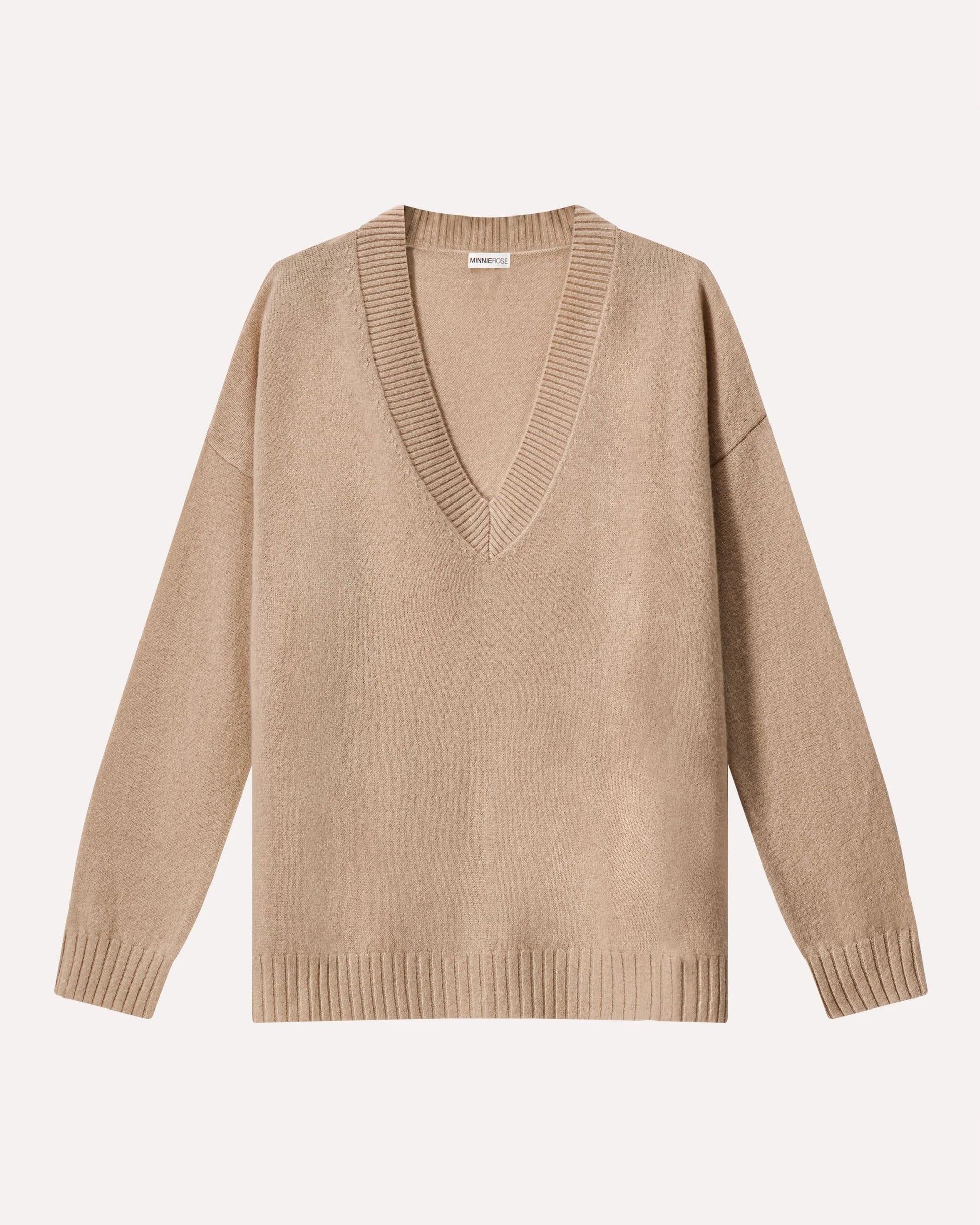 Beige sweater with a deep V-neck on a light beige background