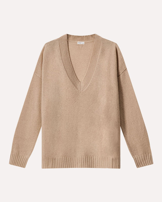 Beige sweater with a deep V-neck on a light beige background