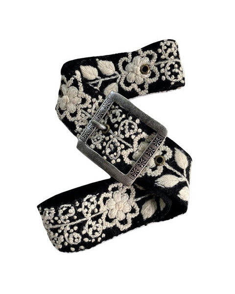 Black belt with floral embroidery on a white background