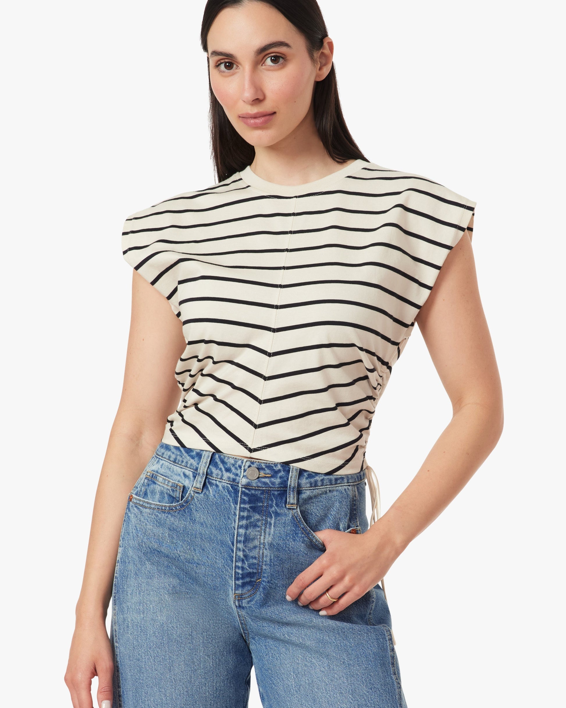 Woman wearing a striped top and jeans on a white background