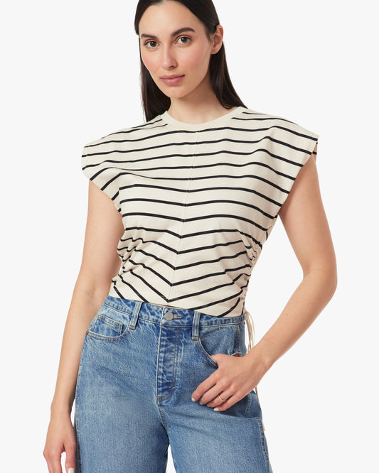 Woman wearing a striped top and jeans on a white background