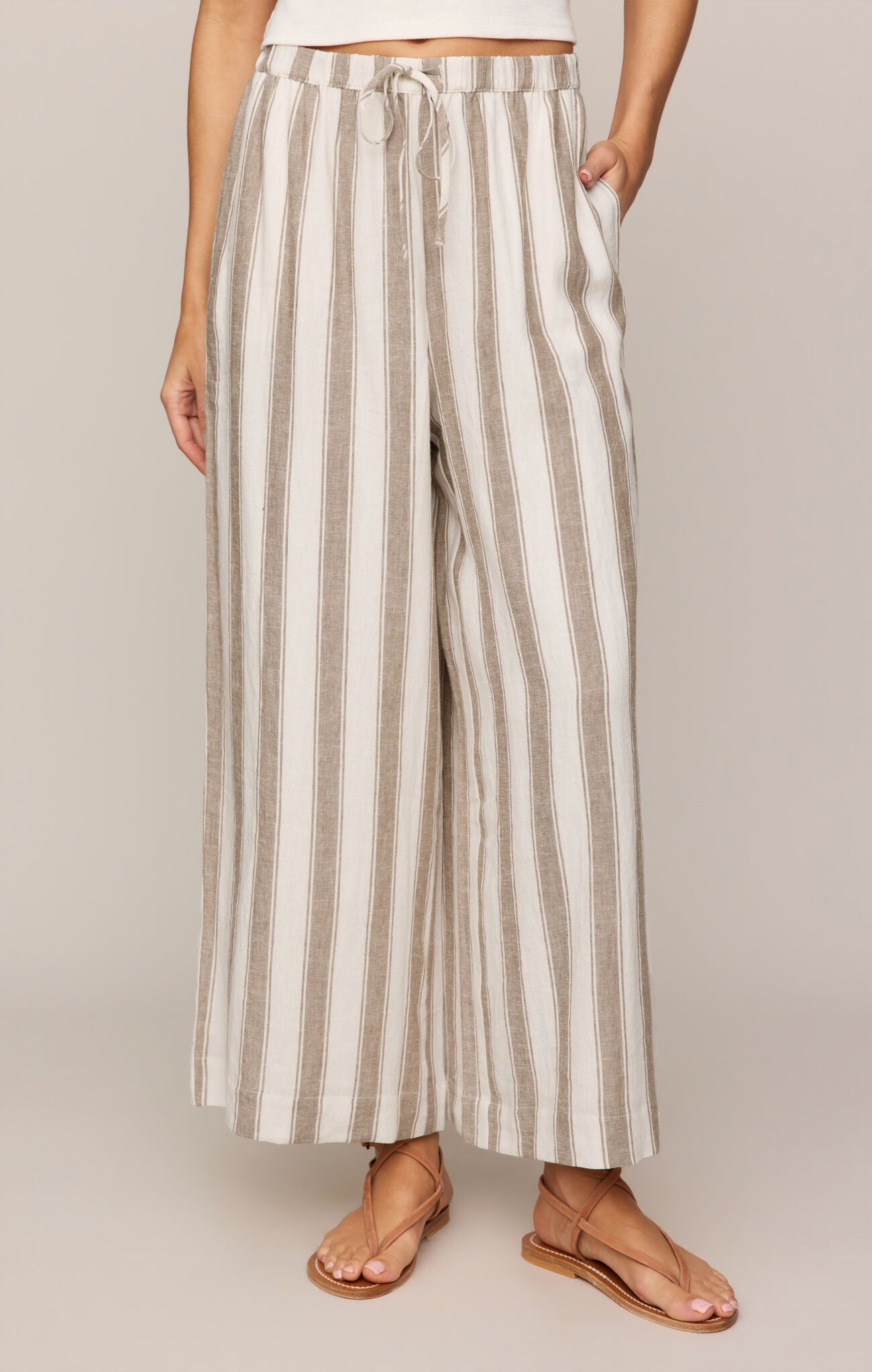 Striped pants worn by a person on a plain background