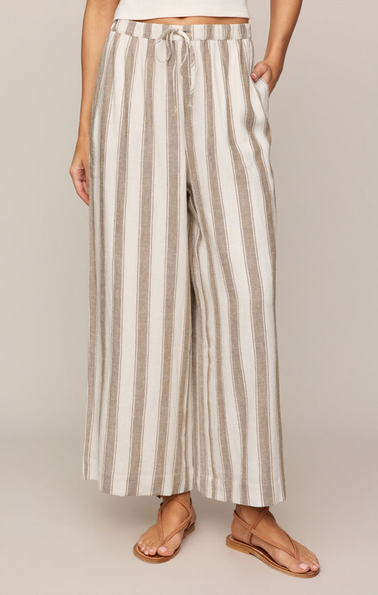 Striped pants worn by a person on a plain background