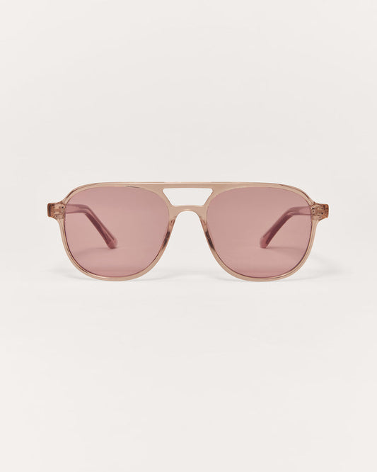 Sunglasses with pink lenses and gold frame on a white background