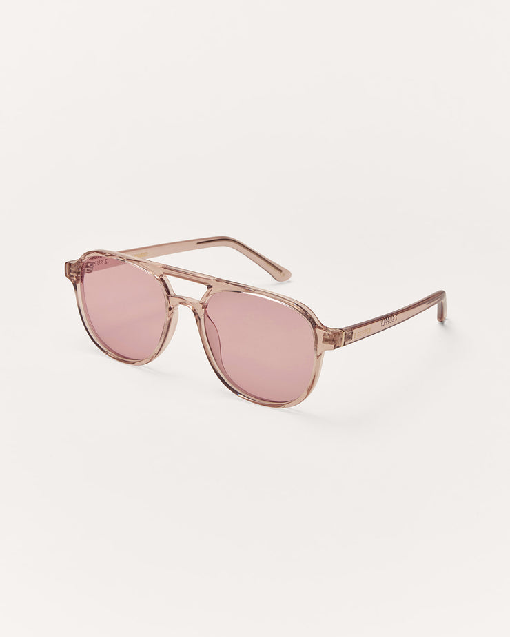 Pink sunglasses with gold frame on a white background