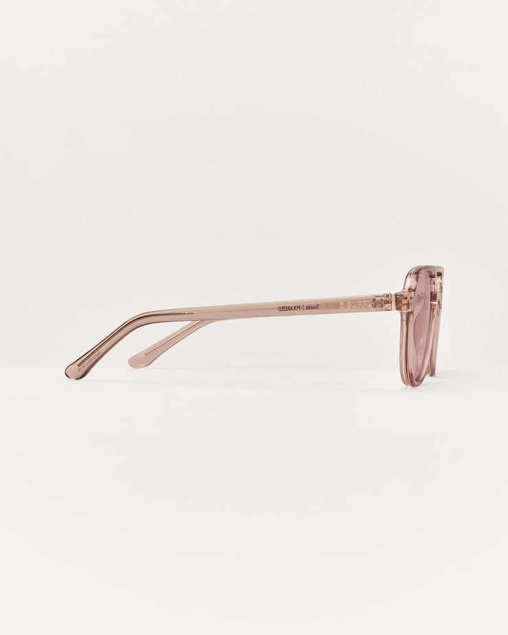 Sunglasses with a thin frame on a light beige background