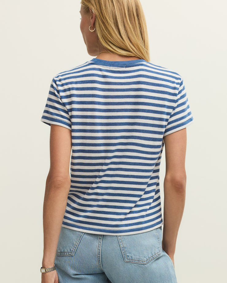 Person wearing a blue and white striped t-shirt and light blue jeans on a plain background