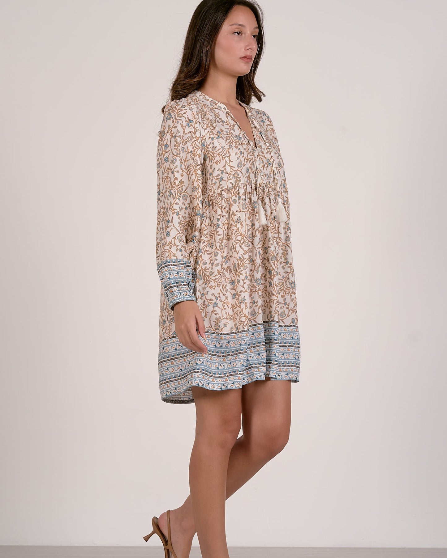 Woman wearing a floral dress with a white background