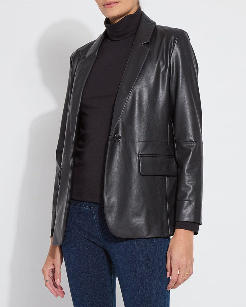 Person wearing a black leather jacket over a black turtleneck and blue jeans on a white background