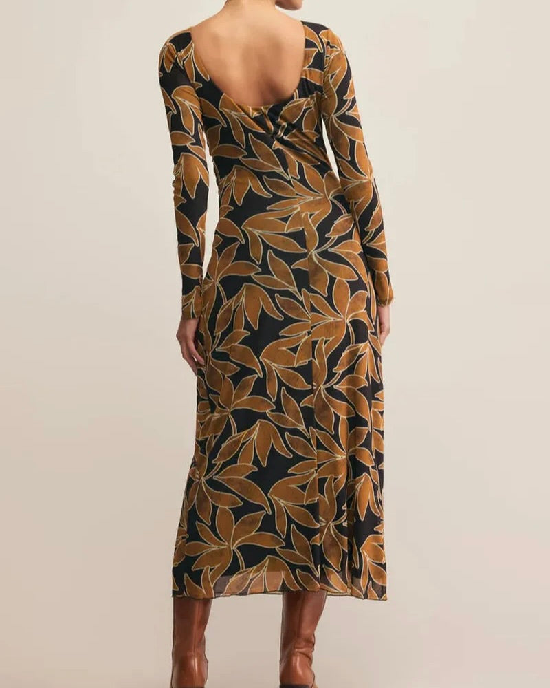 Patterned dress with long sleeves on a plain background