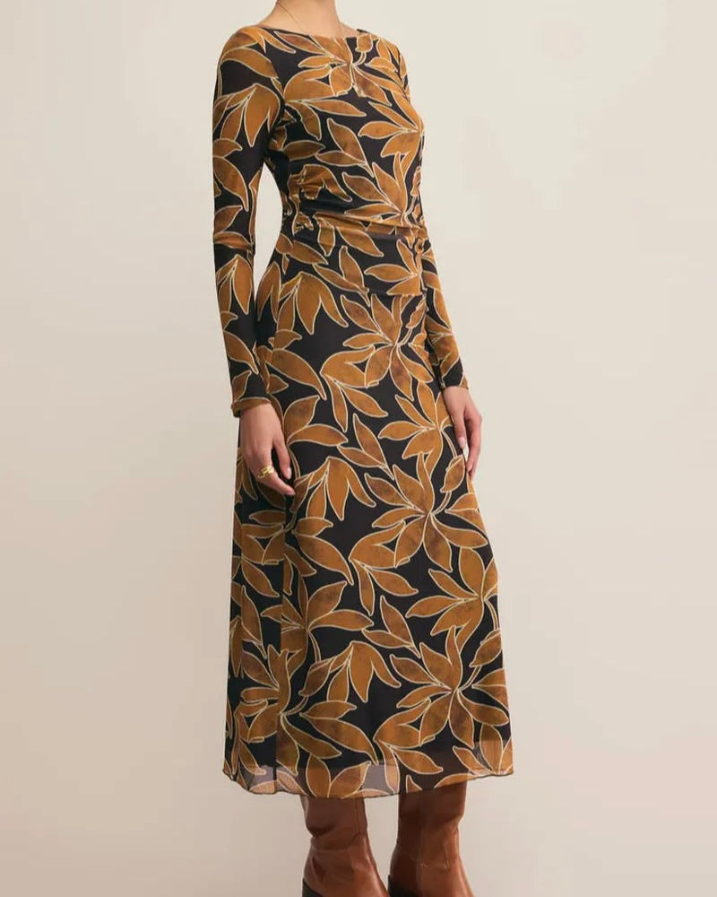 Long-sleeve dress with leaf pattern on a plain background