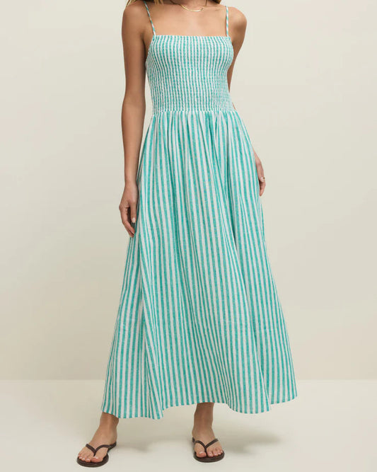 Woman wearing a green and white striped dress on a white background
