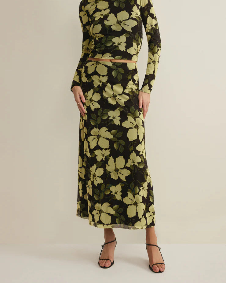 Woman wearing a floral dress with a neutral background