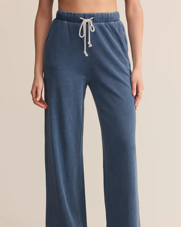 Blue lounge pants with a drawstring on a beige background