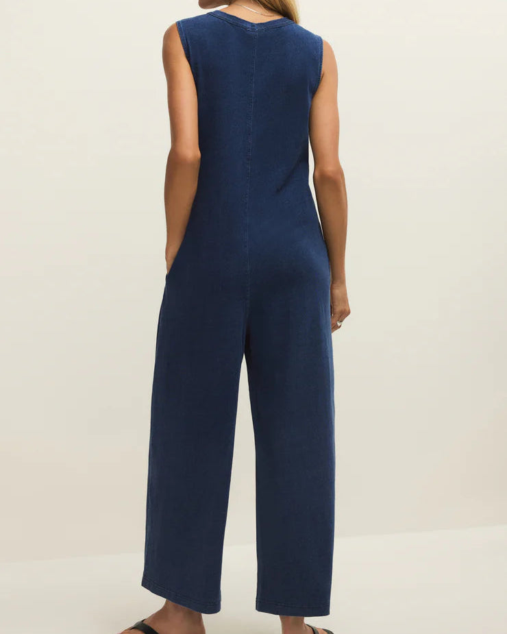 Woman wearing a blue jumpsuit on a white background