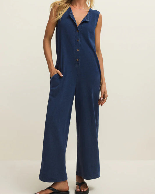 Woman wearing a blue jumpsuit on a white background