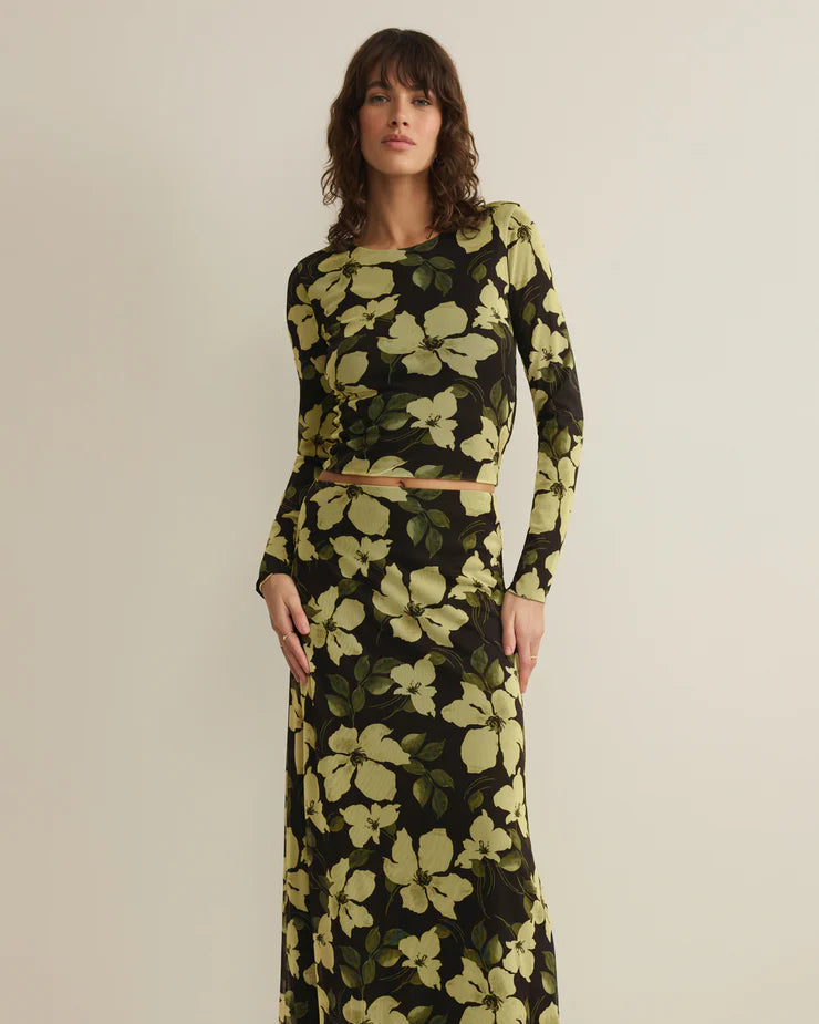 Woman wearing a floral dress with a neutral background
