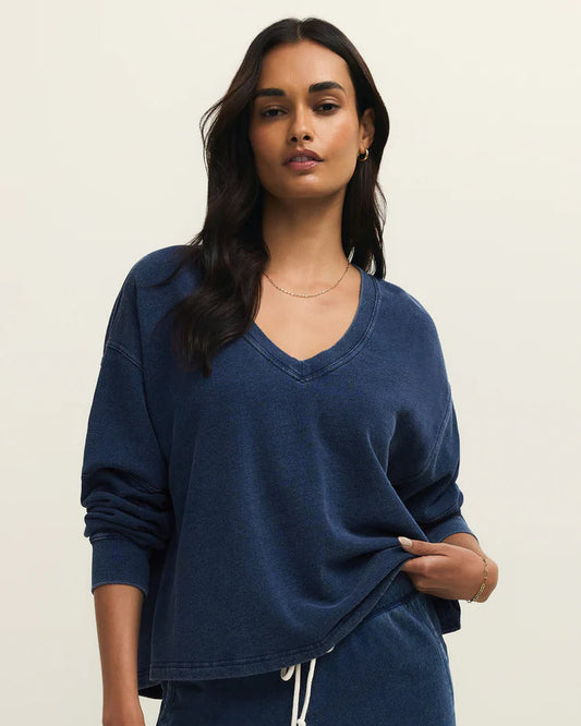 Woman wearing a blue outfit with a plain background