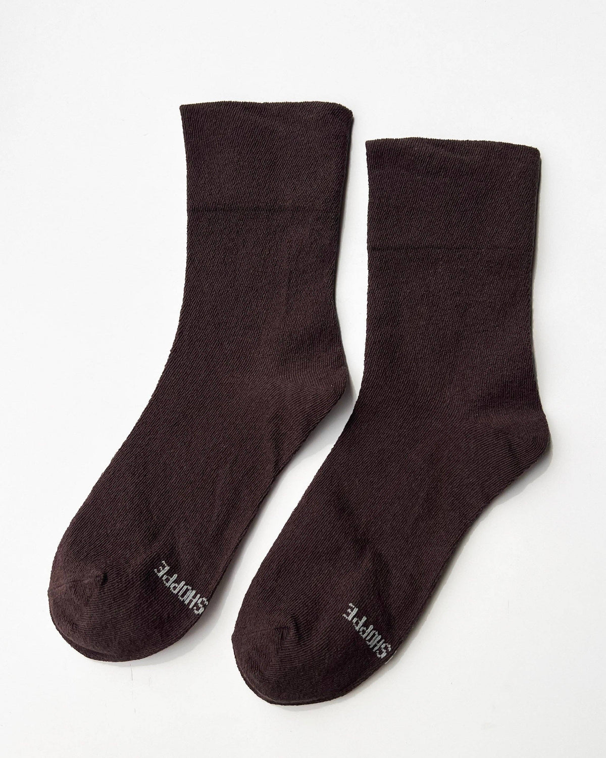 Pair of dark brown socks on a white background