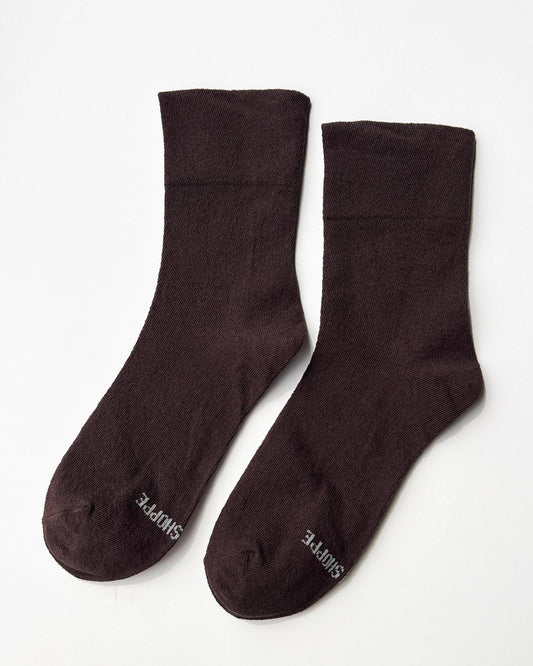 Pair of dark brown socks on a white background
